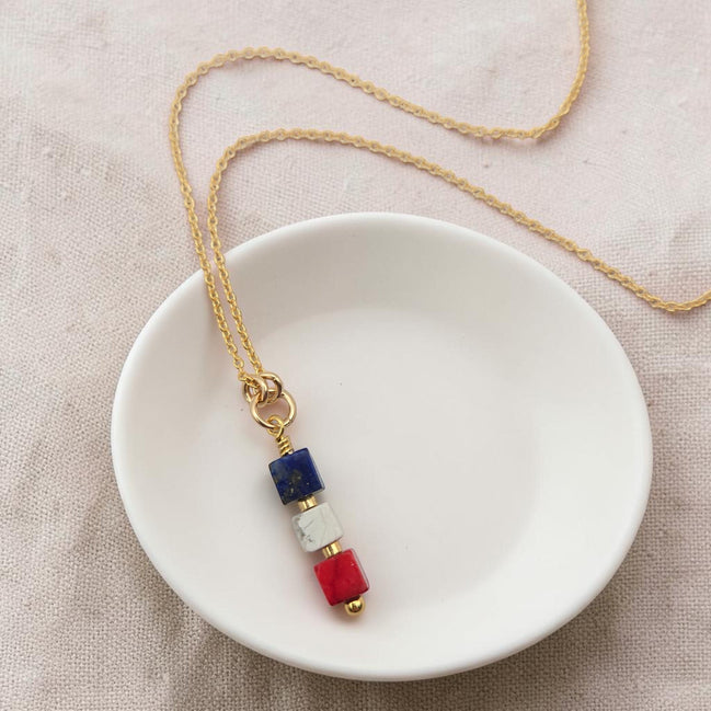 Bijou by SAM Liberty necklace featuring red, white, and blue sea sediment jasper cube stones on a gold chain.