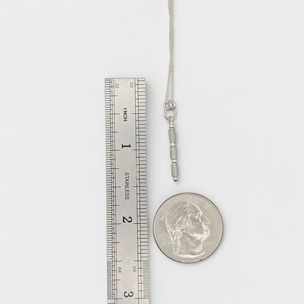Bijou by SAM Mossy Creek necklace with green aventurine tube beads and sterling silver chain next to a ruler and coin.