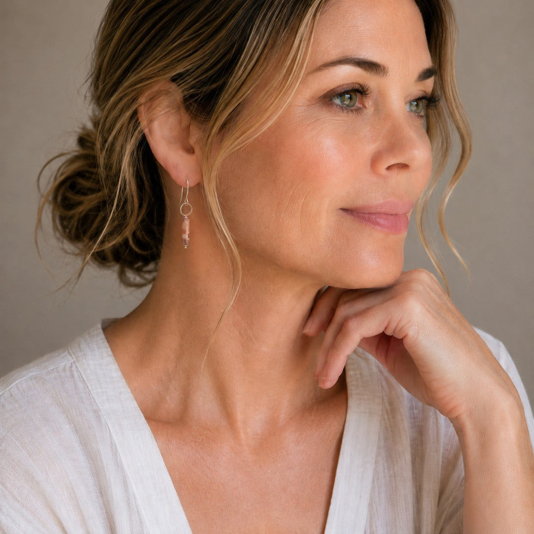 Bijou by SAM Olivia earrings featuring a Redline Jasper cylinder on a sterling silver hoop worn by a woman.