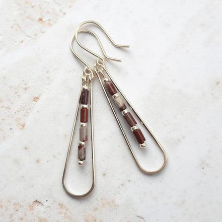Bijou by SAM Painted Bluff teardrop hoop earrings featuring maroon and gray Red Rainbow Jasper tube beads in silver.