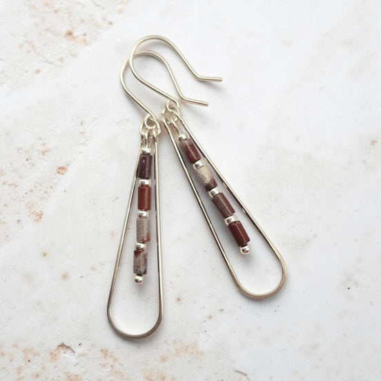 Bijou by SAM Painted Bluff teardrop hoop earrings featuring maroon and gray Red Rainbow Jasper tube beads in silver.