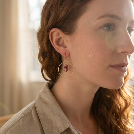 Bijou by SAM handmade gold hoop earrings featuring a delicate stack of square-cut pink Thulite stones on a model