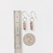 Bijou by SAM Olivia earrings featuring cylindrical Redline Jasper stones on sterling silver hoops with a scale ruler.