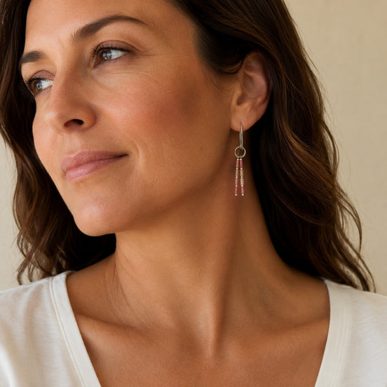 Bijou by SAM Rose Bluff dangle earrings featuring pink rhodonite tube beads on sterling silver hoops worn by a woman.