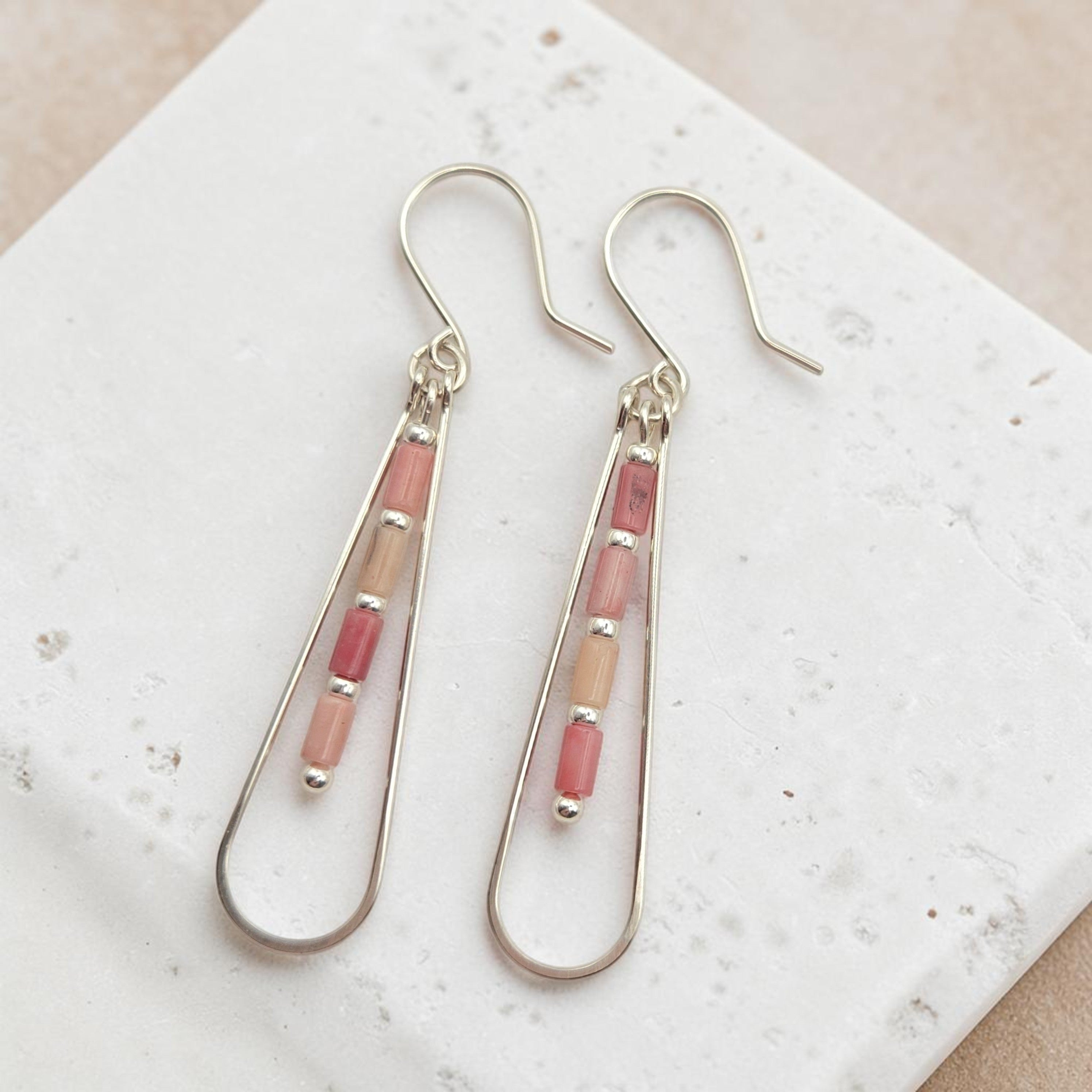 Bijou by SAM Rose Bluff teardrop earrings featuring pink Rhodonite tube beads on silver hoops.