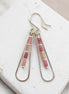 Bijou by SAM Rose Bluff teardrop hoop earrings featuring pink Rhodonite tube beads on sterling silver wire.