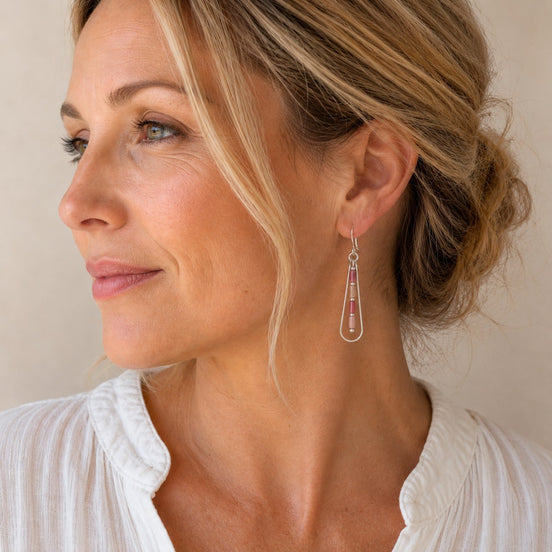 Bijou by SAM Rose Bluff teardrop earrings with pink Rhodonite beads on a woman wearing a white top