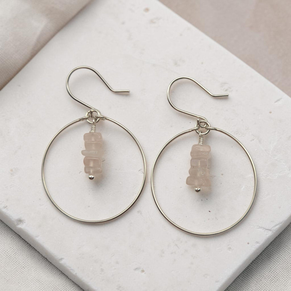 Bijou by SAM handmade sterling silver hoop earrings featuring a delicate stack of square-cut pale pink Rose Quartz.