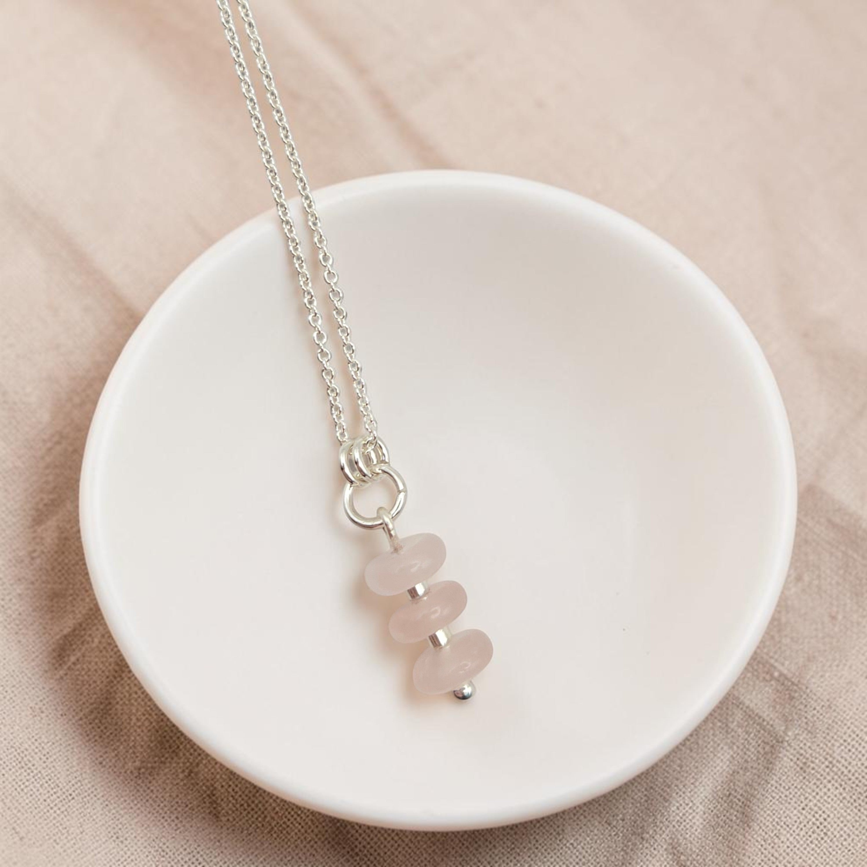Bijou by SAM Aurora necklace featuring three soft blush rose quartz beads on a delicate sterling silver chain.