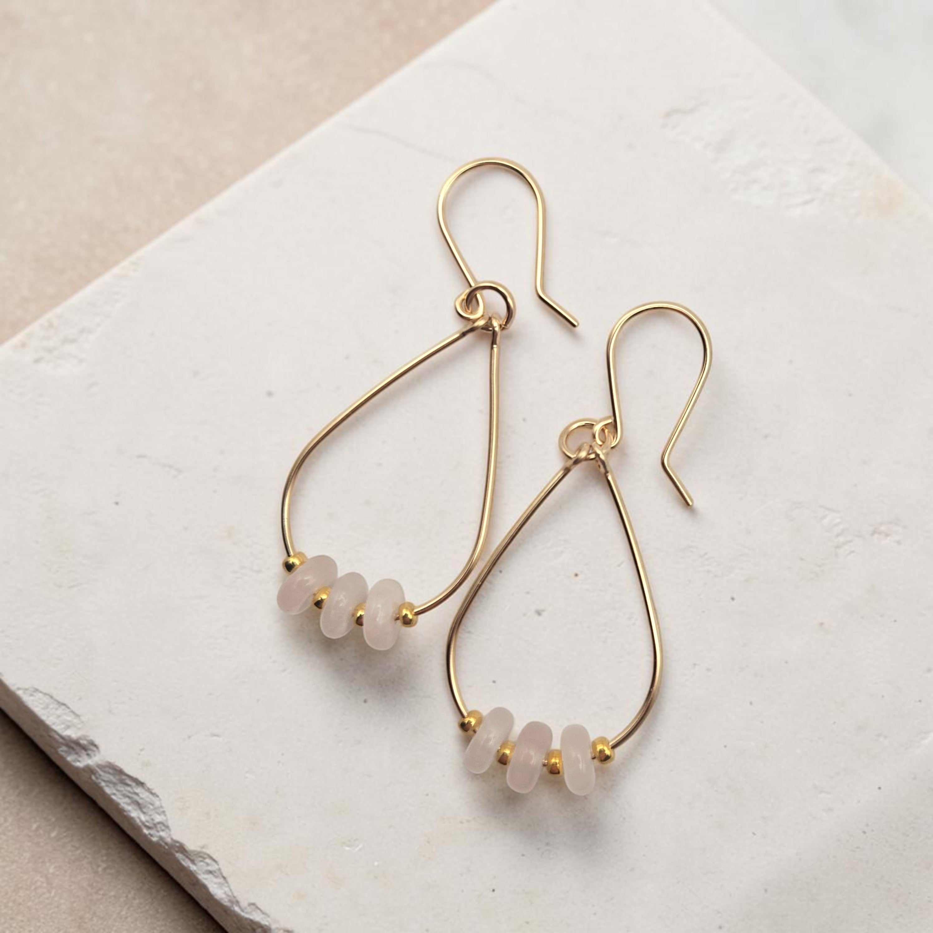 Bijou by SAM Aurora teardrop hoop earrings featuring blush rose quartz beads on 14k gold fill wire.