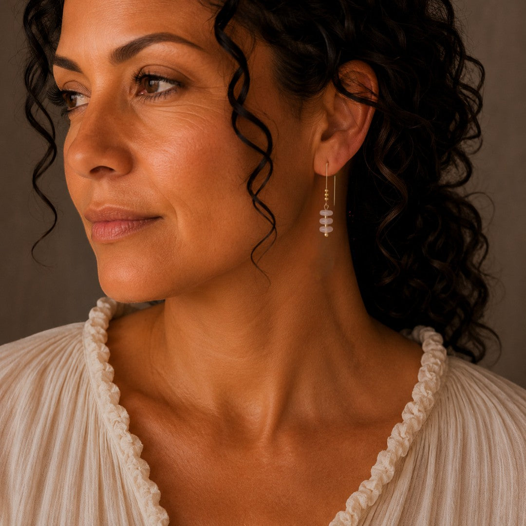 Bijou by SAM Aurora threader earrings featuring blush pink rose quartz beads on 14k gold fill wire worn by a woman.