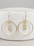 Bijou by SAM handmade gold hoop earrings featuring delicate square-cut rutilated quartz stones on a white stand.
