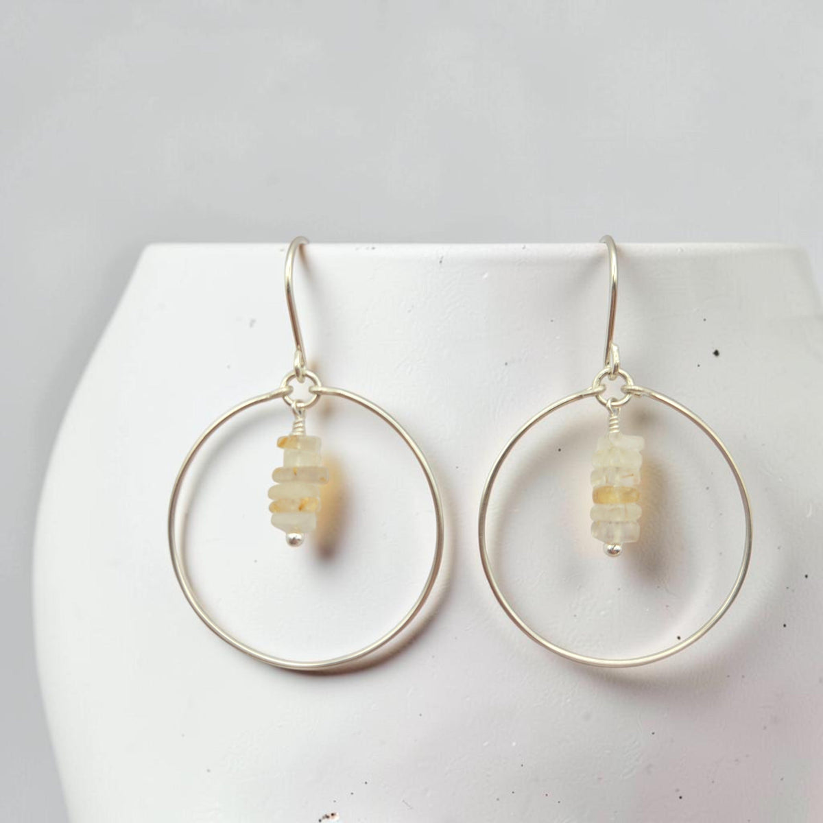 Bijou by SAM handmade sterling silver hoop earrings featuring a delicate stack of pale yellow rutilated quartz stones.