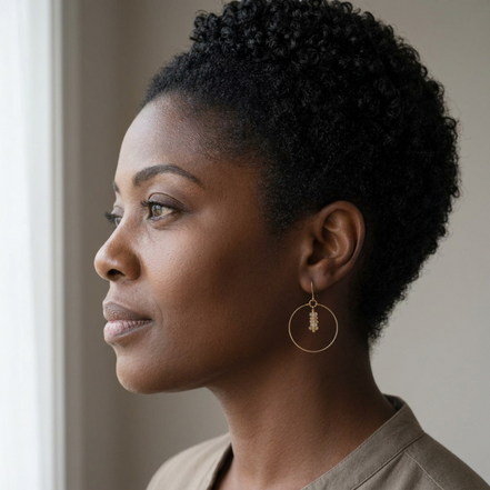 Bijou by SAM handmade gold hoop earrings featuring delicate square-cut rutilated quartz stones worn by a woman