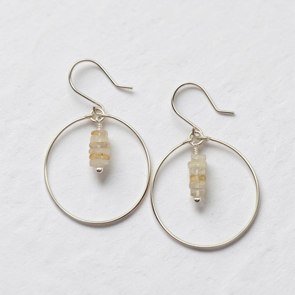 Bijou by SAM handmade sterling silver hoop earrings featuring a delicate stack of pale yellow rutilated quartz stones.