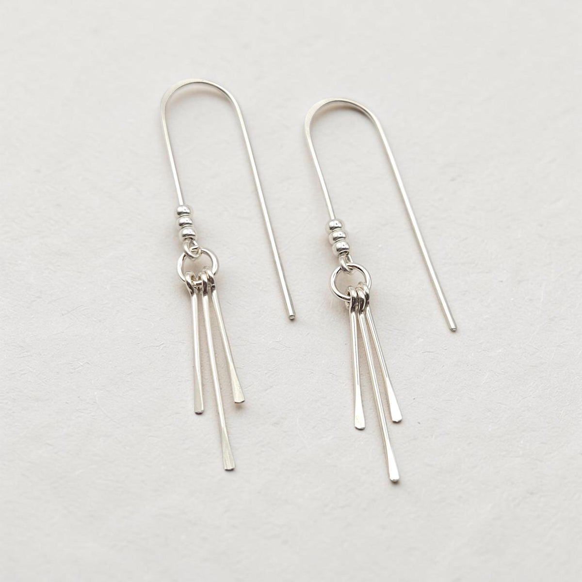 Bijou by SAM minimalist sterling silver threader earrings featuring three delicate metal fringes on a polished hoop.