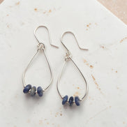 Bijou by SAM Milky Way teardrop hoop earrings featuring deep blue sodalite stones on sterling silver wire.