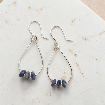 Bijou by SAM Milky Way teardrop hoop earrings featuring deep blue sodalite stones on sterling silver wire.