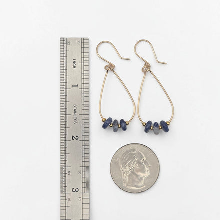 Bijou by SAM Milky Way teardrop hoop earrings with blue sodalite stones and gold fill wire shown next to a ruler and coin