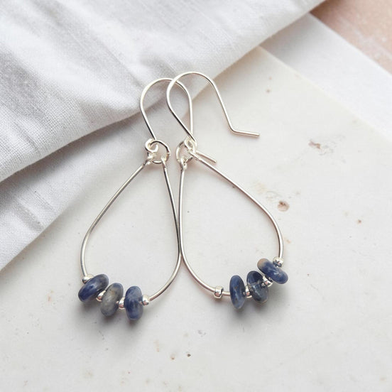 Bijou by SAM Milky Way teardrop hoop earrings featuring deep blue sodalite stones on sterling silver wire.