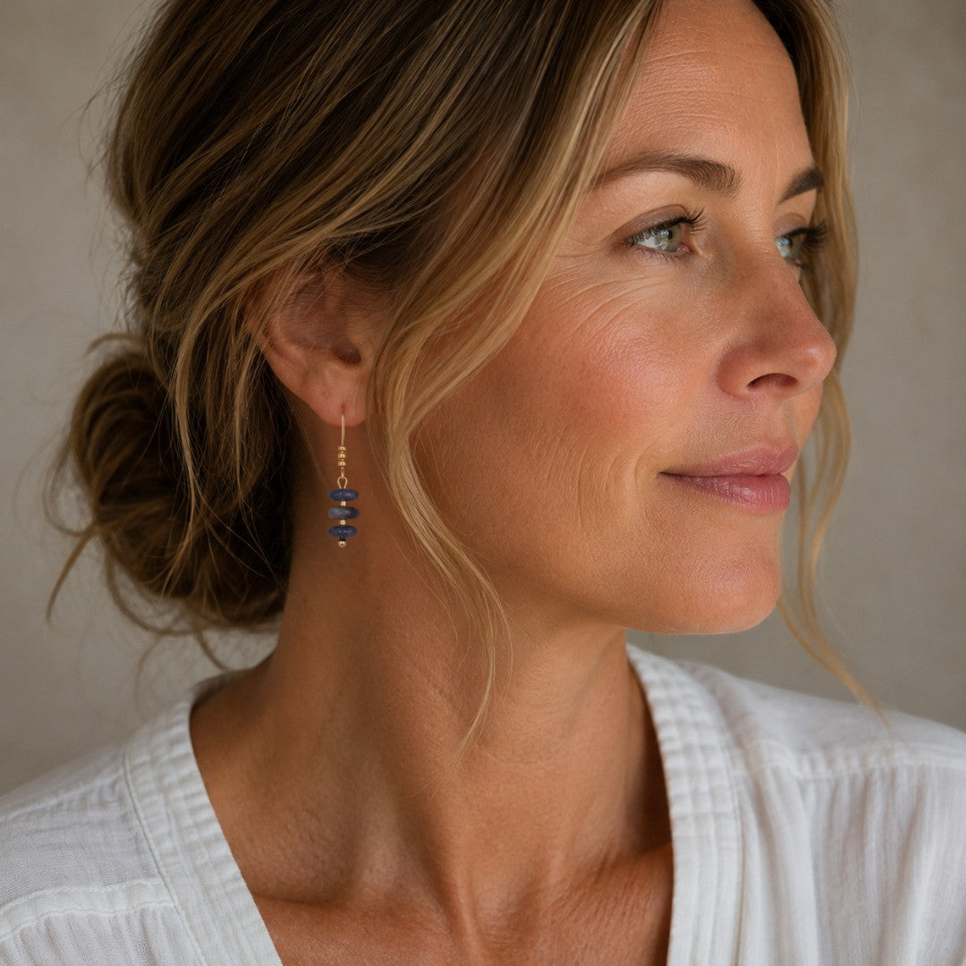 Bijou by SAM Milky Way threader earrings featuring deep blue sodalite beads on 14k gold fill worn by a woman.