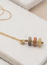 Bijou by SAM Stardust necklace featuring three small crazy lace agate stones in cream, coral, and tan on a gold chain.