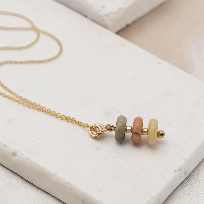 Bijou by SAM Stardust necklace featuring three small crazy lace agate stones in cream, coral, and tan on a gold chain.