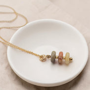 Bijou by SAM Stardust necklace featuring three small crazy lace agate beads in cream and coral on a gold chain
