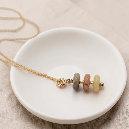 Bijou by SAM Stardust necklace featuring three small crazy lace agate beads in cream and coral on a gold chain