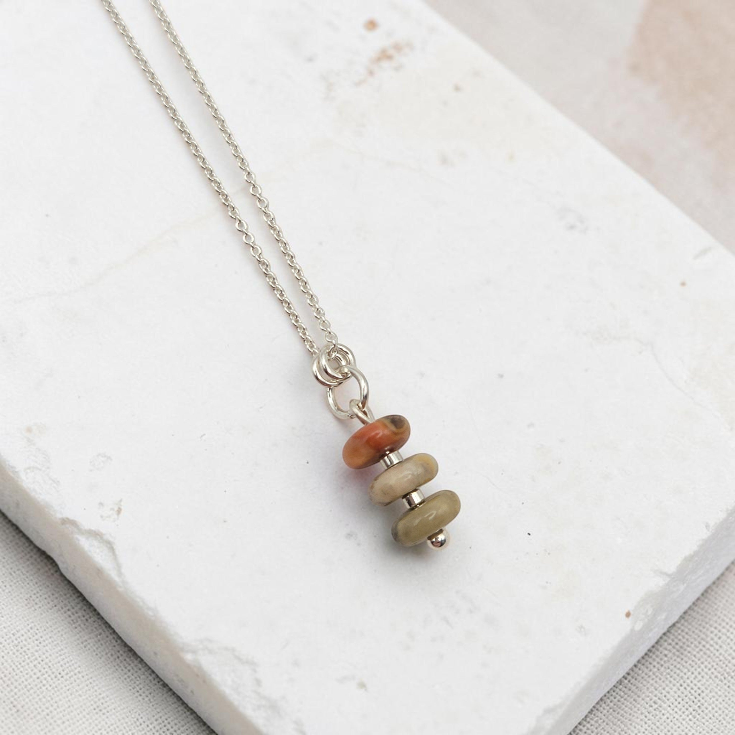Bijou by SAM Stardust necklace featuring three stacked crazy lace agate stones in cream, coral, and tan on a silver chain