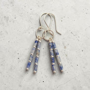 Bijou by SAM Stone Creek earrings with blue spot jasper tube beads and sterling silver hoops on a grey background.