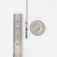 Bijou by SAM Stone Creek necklace with blue spot jasper tube beads and sterling silver chain next to a ruler and coin