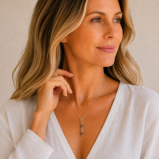 Bijou by SAM Stone Creek necklace featuring blue spot jasper tube beads on a silver chain worn by a woman