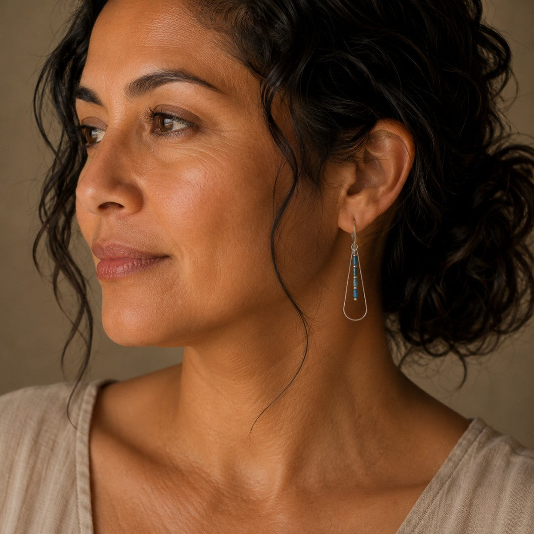 Bijou by SAM Still Water teardrop earrings with blue Apatite beads worn by a woman in profile