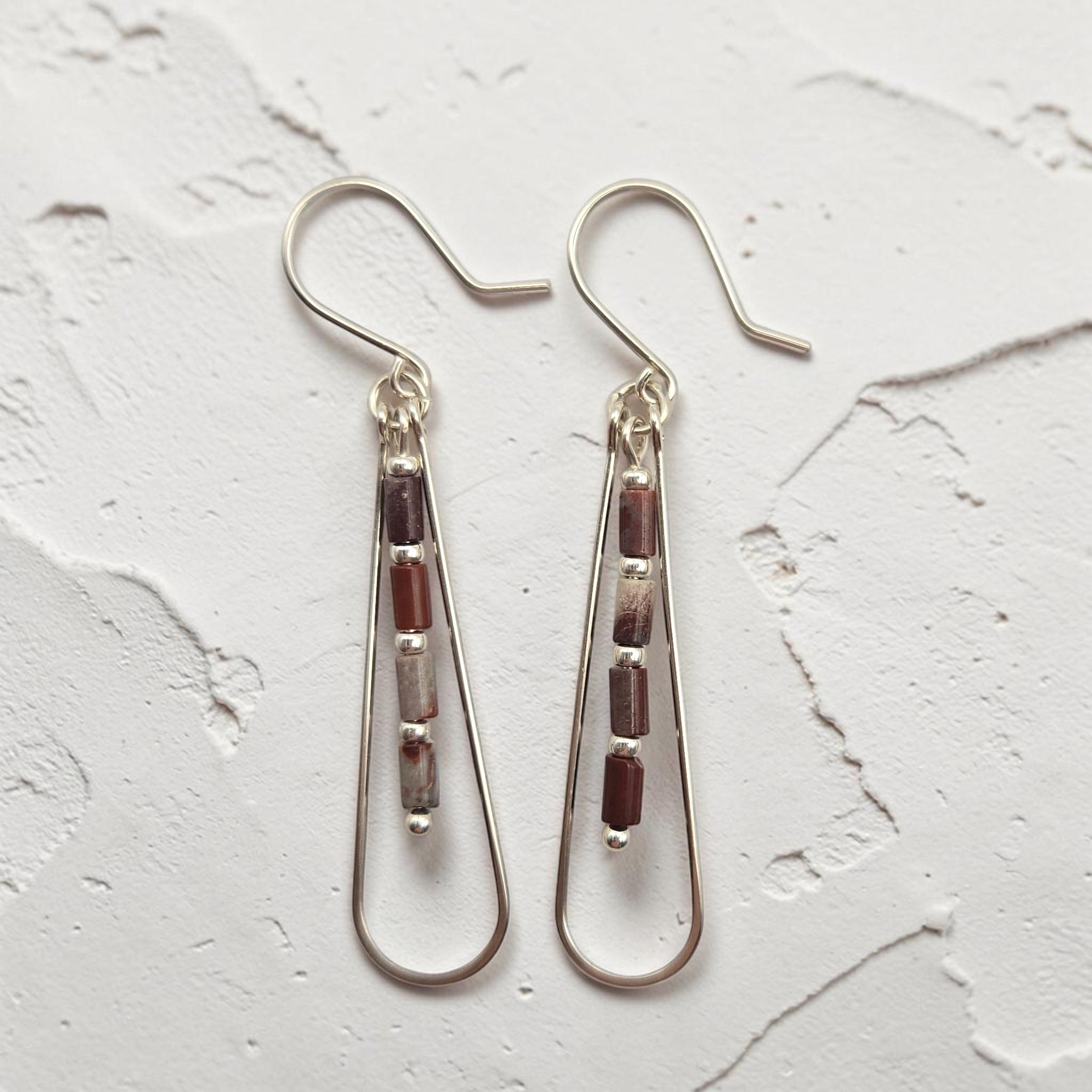 Bijou by SAM Painted Bluff teardrop hoop earrings with maroon and gray Red Rainbow Jasper beads in sterling silver.