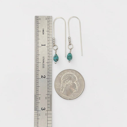 Bijou by SAM handcrafted sterling silver threader earrings featuring genuine teardrop turquoise stones next to a ruler
