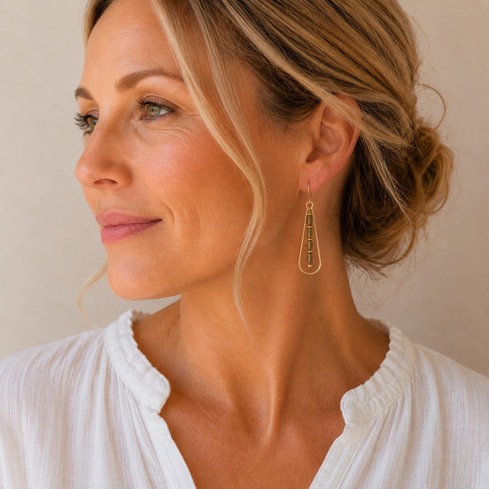 Bijou by SAM Forest Floor teardrop earrings with green Unakite beads on a woman wearing a white top