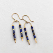 Bijou by SAM wishbone earrings featuring blue lapis lazuli tube stones and 14k gold fill wire on a white background.