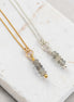 Two necklaces with Labradorite beads on a marble surface