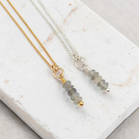 Two necklaces with Labradorite beads on a marble surface
