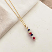 Necklace with colorful beads on a light fabric background