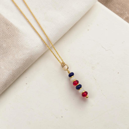 Necklace with colorful beads on a light fabric background