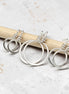 set of three handmade sterling silver hoop stud earrings on a concrete surface